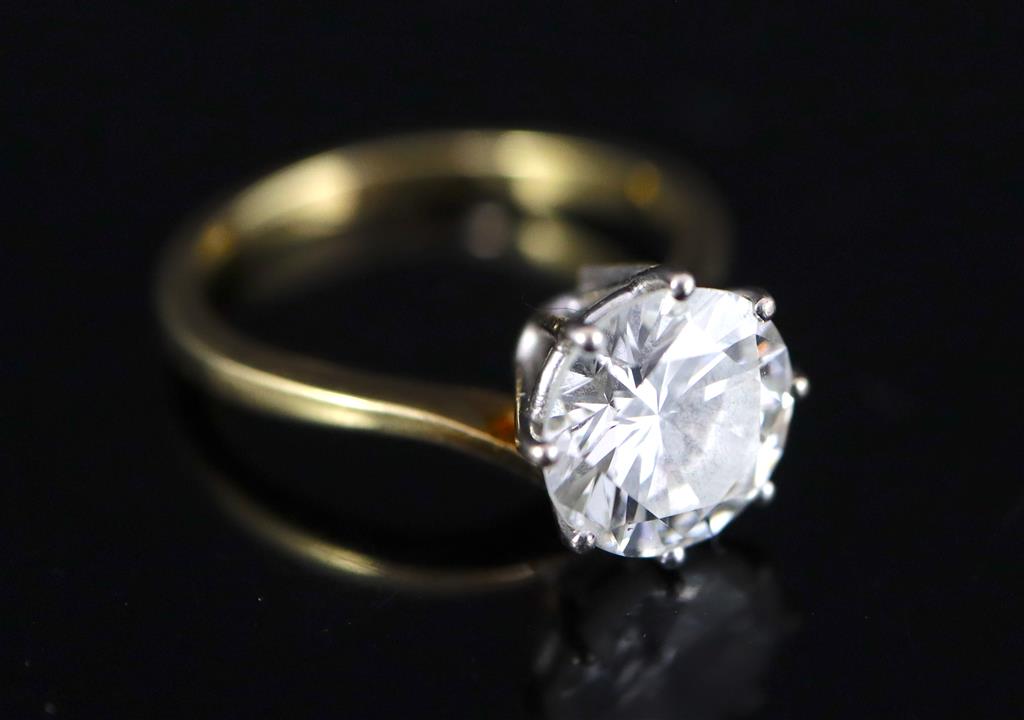 A modern 18ct gold and solitaire brilliant cut diamond ring,